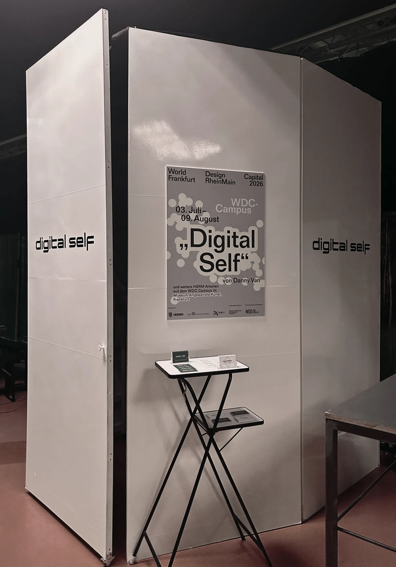 White booth with exhibition poster